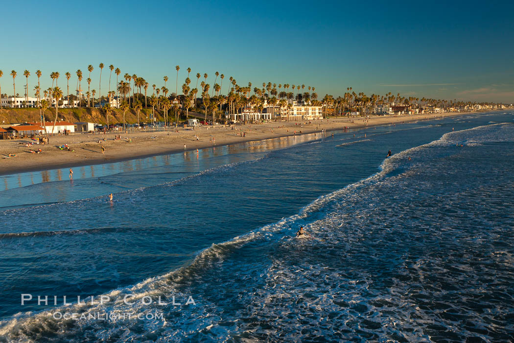 The coast of Oceanside California, waves and surfers, beach houses, just before sunset, winter, looking south. Oceanside Pier, USA, natural history stock photograph, photo id 27599