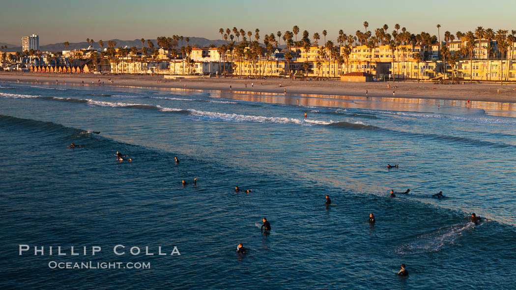 The coast of Oceanside California, waves and surfers, beach houses, just before sunset, winter, looking north. Oceanside Pier, USA, natural history stock photograph, photo id 27605
