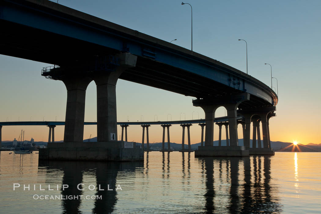 Coronado Bridge, linking San Diego to Coronado, sunrise, viewed from Coronado Island. San Diego Coronado Bridge, known locally as the Coronado Bridge, links San Diego with Coronado, California. The bridge was completed in 1969 and was a toll bridge until 2002. It is 2.1 miles long and reaches a height of 200 feet above San Diego Bay. USA, natural history stock photograph, photo id 27097