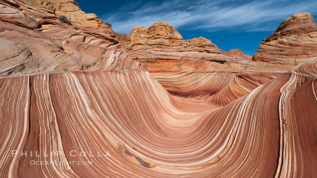 The Wave, an area of fantastic eroded sandstone featuring beautiful swirls, wild colors, countless striations, and bizarre shapes set amidst the dramatic surrounding North Coyote Buttes of Arizona and Utah.  The sandstone formations of the North Coyote Buttes, including the Wave, date from the Jurassic period. Managed by the Bureau of Land Management, the Wave is located in the Paria Canyon-Vermilion Cliffs Wilderness and is accessible on foot by permit only. USA, natural history stock photograph, photo id 20693