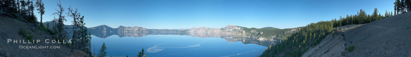 Panorama of Crater Lake, early morning.  Crater Lake is the six-mile wide lake inside the collapsed caldera of volcanic Mount Mazama. Crater Lake is the deepest lake in the United States and the seventh-deepest in the world. Its maximum recorded depth is 1996 feet (608m). It lies at an altitude of 6178 feet (1880m). Crater Lake National Park, Oregon, USA, natural history stock photograph, photo id 19115