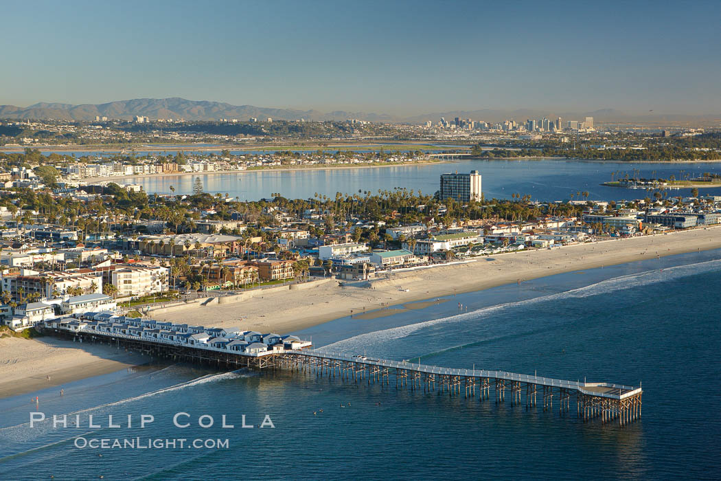 Crystal Pier, 872 feet long and built in 1925, extends out into the Pacific Ocean from the town of Pacific Beach.  Mission Bay and downtown San Diego are seen in the distance. California, USA, natural history stock photograph, photo id 22361