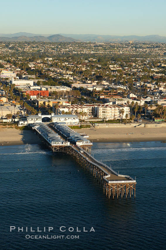Crystal Pier, 872 feet long and built in 1925, extends out into the Pacific Ocean from the town of Pacific Beach.  Mission Bay and downtown San Diego are seen in the distance. California, USA, natural history stock photograph, photo id 22465