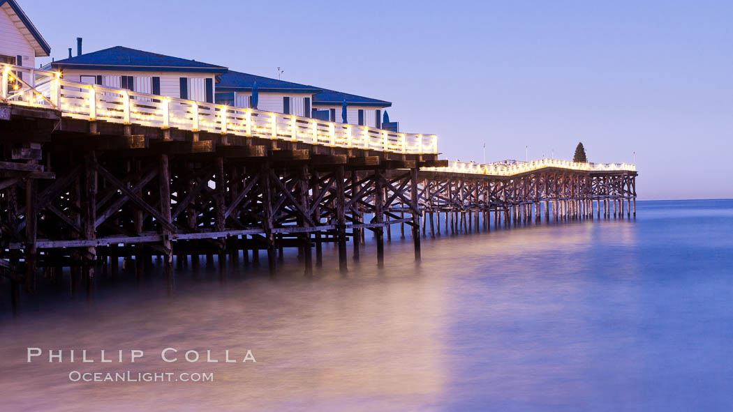 The Crystal Pier and Pacific Ocean at sunrise, dawn, waves blur as they crash upon the sand.  Crystal Pier, 872 feet long and built in 1925, extends out into the Pacific Ocean from the town of Pacific Beach. California, USA, natural history stock photograph, photo id 27240