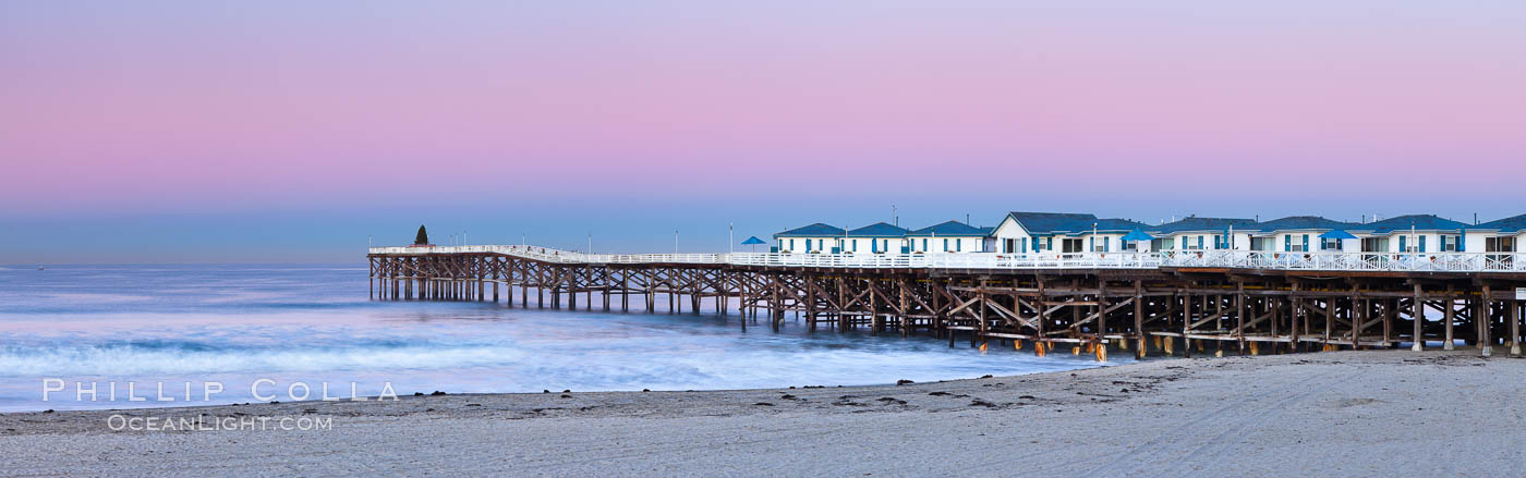 The Crystal Pier and Pacific Ocean at sunrise, dawn, waves blur as they crash upon the sand.  Crystal Pier, 872 feet long and built in 1925, extends out into the Pacific Ocean from the town of Pacific Beach. California, USA, natural history stock photograph, photo id 27244
