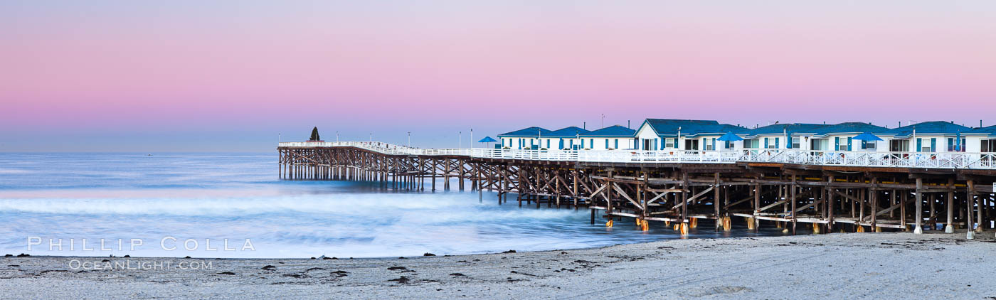 The Crystal Pier and Pacific Ocean at sunrise, dawn, waves blur as they crash upon the sand.  Crystal Pier, 872 feet long and built in 1925, extends out into the Pacific Ocean from the town of Pacific Beach. California, USA, natural history stock photograph, photo id 27245
