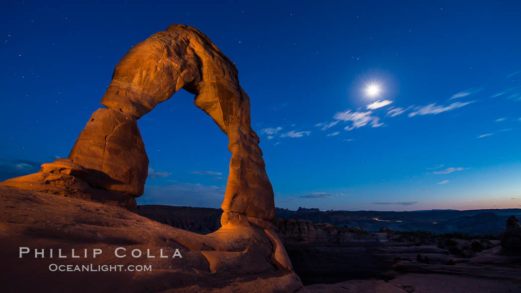 Delicate Arch and the Moon at Sunset.  The moon and clouds, with stars showing faintly in the sky, as sunset fades into night. Arches National Park, Utah, USA, natural history stock photograph, photo id 27859