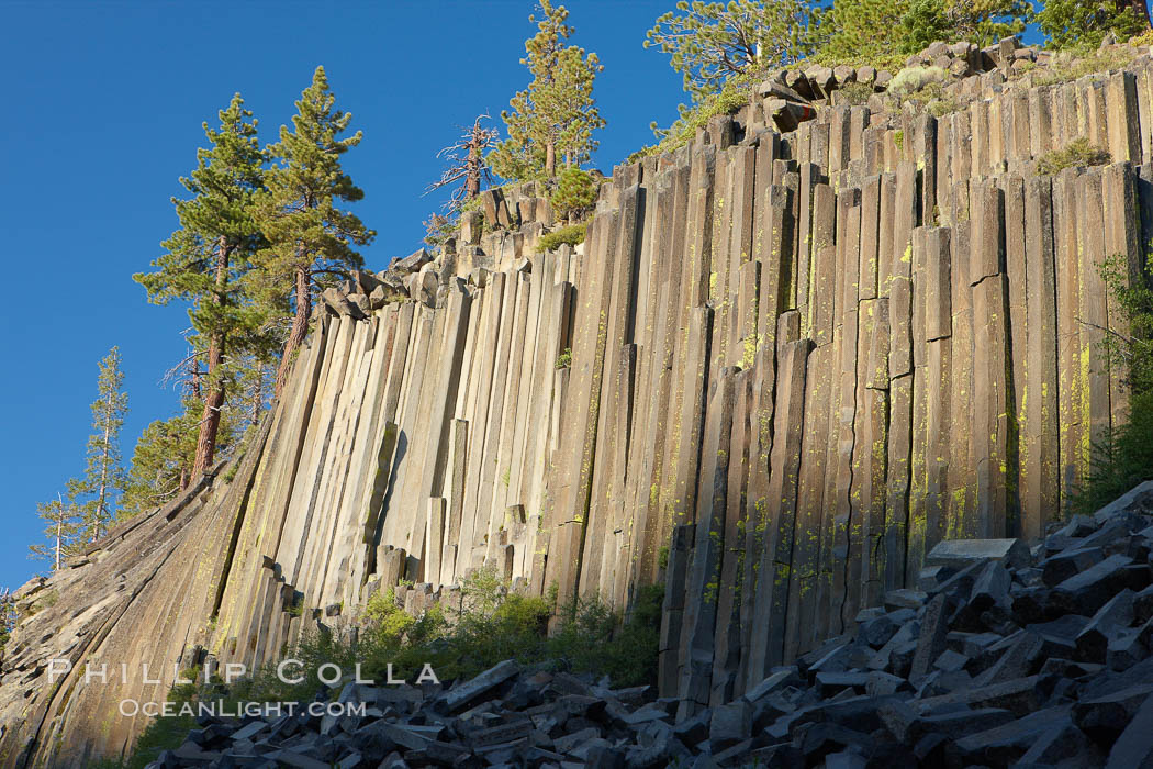 Devil's Postpile, a spectacular example of columnar basalt.  Once molten and under great pressure underground, the lava that makes up Devil's Postpile cooled evenly and slowly, contracting and fracturing into polygonal-sided columns.  The age of the formation is estimated between 100 and 700 thousand years old.  Sometime after the basalt columns formed, a glacier passed over the formation, cutting and polishing the tops of the columns.  The columns have from three to seven sides, varying because of differences in how quickly portions of the lava cooled, Devils Postpile National Monument, California