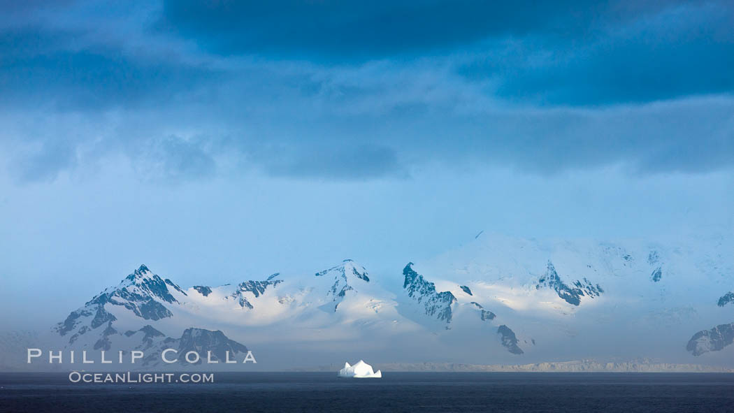Distant icebergs, mountains, clouds, ocean at dawn, in the South Shetland Islands, near Deception Island. Antarctic Peninsula, Antarctica, natural history stock photograph, photo id 25460