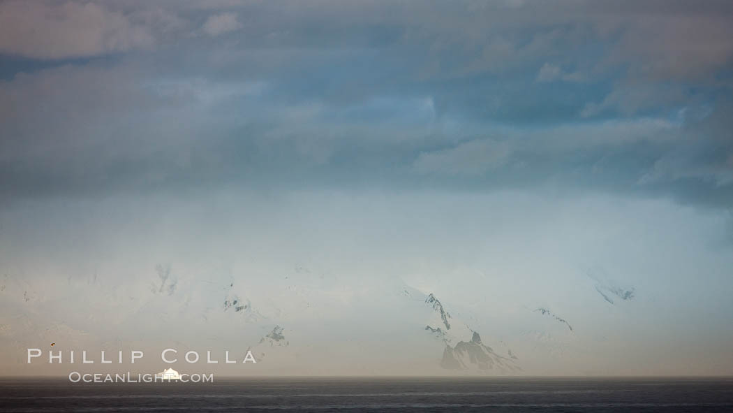 Distant icebergs, mountains, clouds, ocean at dawn, in the South Shetland Islands, near Deception Island. Antarctic Peninsula, Antarctica, natural history stock photograph, photo id 25492