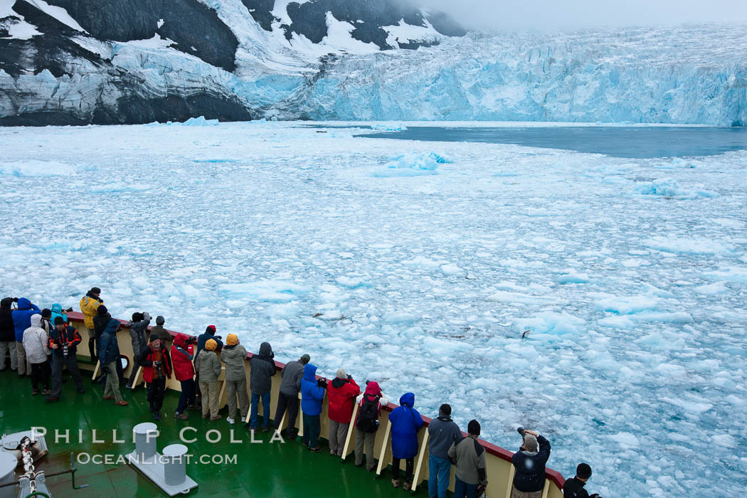 Drygalski Fjord, passengers on icebreak M/V Polar Star.  The water is packed with brash ice which has broken away from Risting Glacier at the end of the narrow fjord