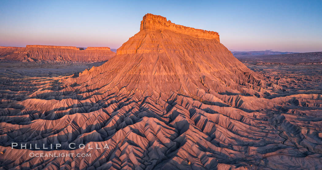 Factory Butte at sunrise. An exceptional example of solitary butte surrounded by dramatically eroded badlands, Factory Butte stands alone on the San Rafael Swell. Hanksville, Utah, USA, natural history stock photograph, photo id 38054
