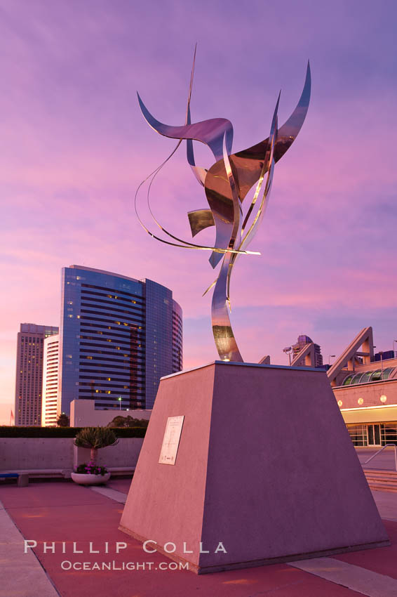 Flama de la Amistad, a statue by Leonardo Nierman.  Installed in the San Diego Convention Centers outdoor amphitheater, Flame of Friendship is a polished, stainless-steel statue set against San Diego Bay weighing 3,700 pounds and standing 20 feet tall and eight feet wide. California, USA, natural history stock photograph, photo id 26558