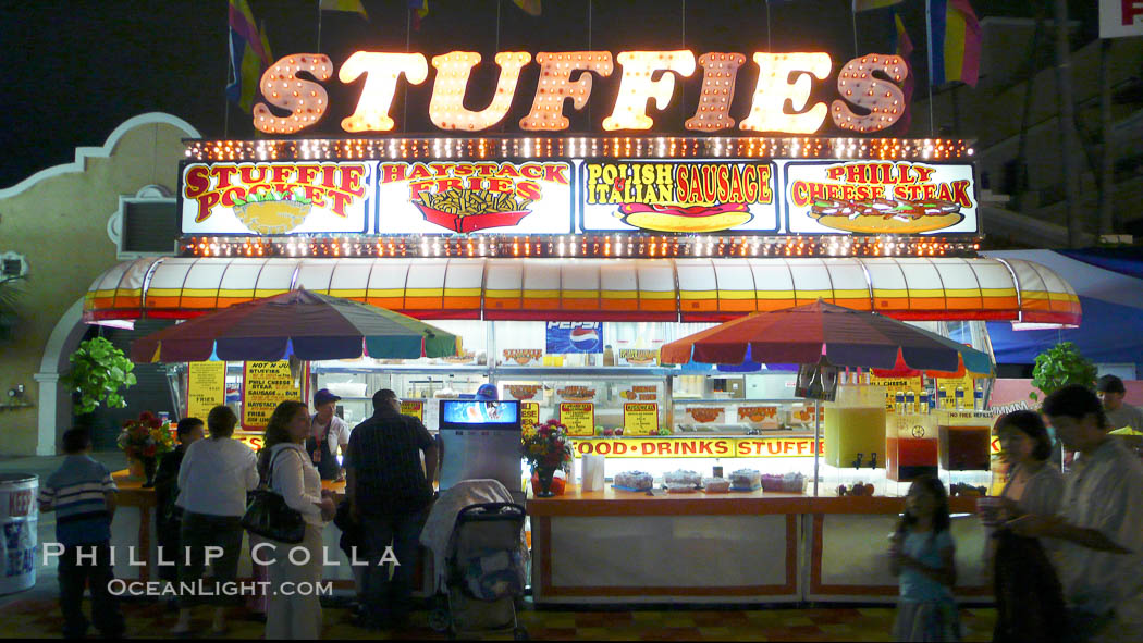 Food vendors at the Del Mar Fair, famous for their tasty, greasy, salty, fattening and generally unwholesome food, which visitors eat by the ton.  Bright lights at night. California, USA, natural history stock photograph, photo id 20880