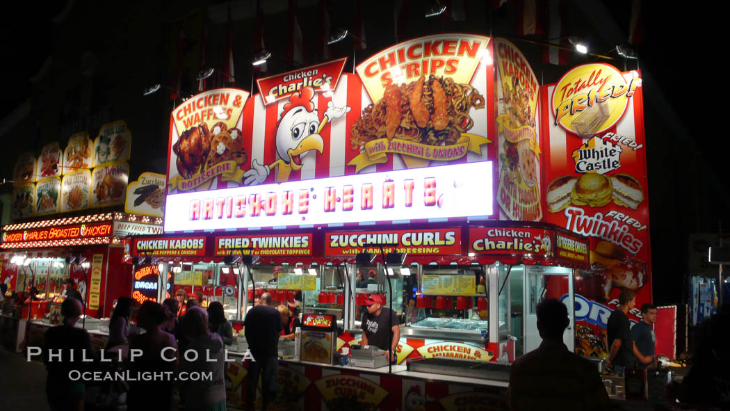 Food vendors at the Del Mar Fair, famous for their tasty, greasy, salty, fattening and generally unwholesome food, which visitors eat by the ton.  Bright lights at night. California, USA, natural history stock photograph, photo id 20881