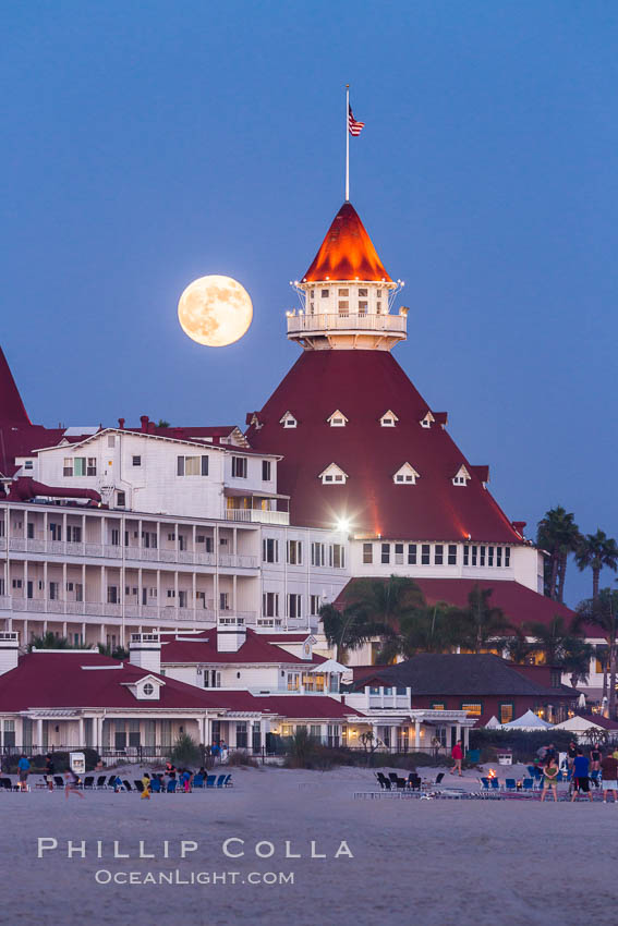 Full Moon Rising over Hotel del Coronado, known affectionately as the Hotel Del. It was once the largest hotel in the world, and is one of the few remaining wooden Victorian beach resorts. It sits on the beach on Coronado Island, seen here with downtown San Diego in the distance. It is widely considered to be one of Americas most beautiful and classic hotels. Built in 1888, it was designated a National Historic Landmark in 1977. California, USA, natural history stock photograph, photo id 29420