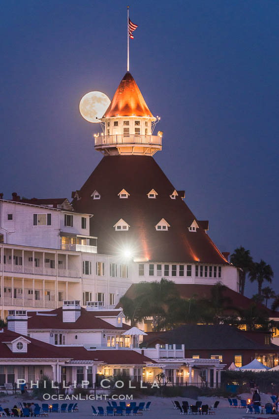 Full Moon Rising over Hotel del Coronado, known affectionately as the Hotel Del. It was once the largest hotel in the world, and is one of the few remaining wooden Victorian beach resorts. It sits on the beach on Coronado Island, seen here with downtown San Diego in the distance. It is widely considered to be one of Americas most beautiful and classic hotels. Built in 1888, it was designated a National Historic Landmark in 1977. California, USA, natural history stock photograph, photo id 29421