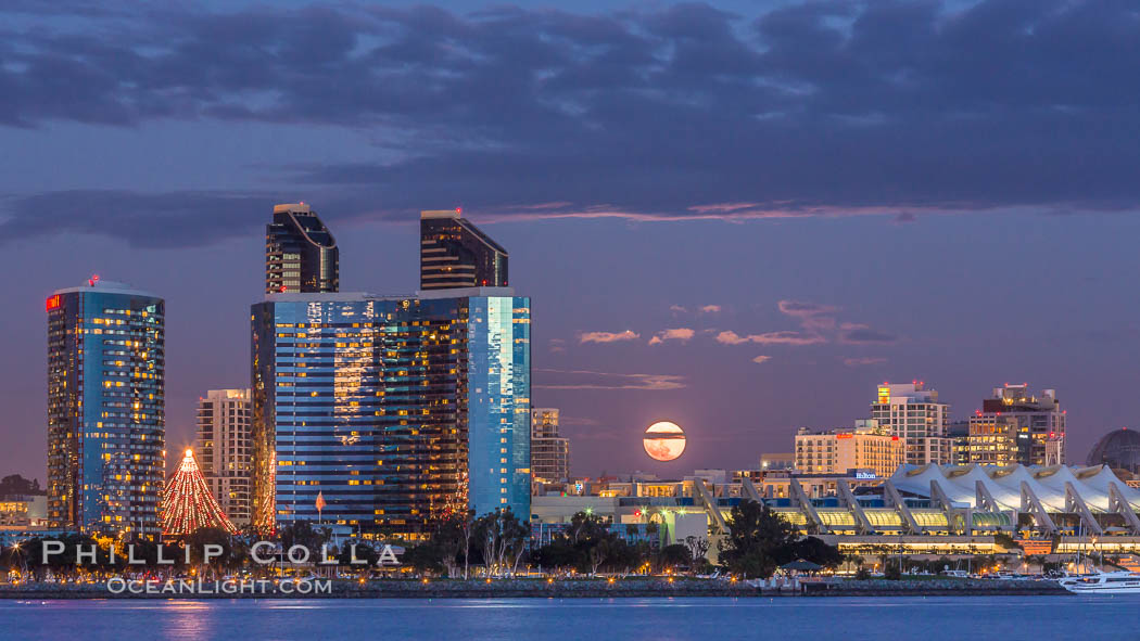 Full moon rising over San Diego city skyline, sunset, storm clouds, viewed from Coronado Island. California, USA, natural history stock photograph, photo id 28022