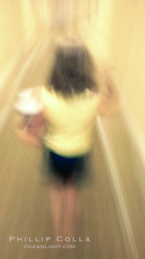 Girl walks down hotel corridor at night, carrying ice bucket, abstract blur time exposure., natural history stock photograph, photo id 20571