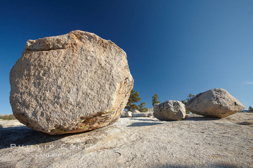 Glacial erratic boulders atop Olmsted Point. Erratics are huge boulders left behind by the passing of glaciers which carved the granite surroundings into their present-day form. When the glaciers melt, any boulders and other geologic material that it was carrying are left in place, sometimes many miles from their original location, Yosemite National Park, California