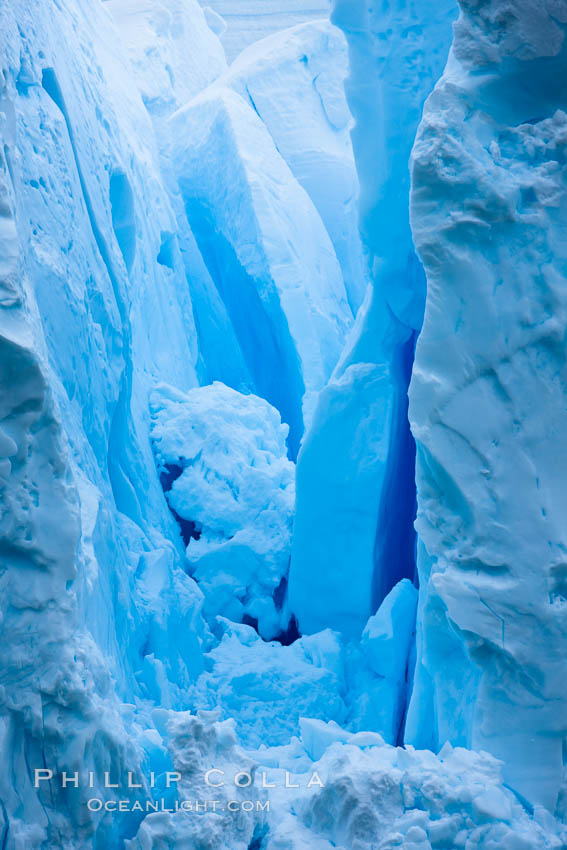 A glacier fractures and cracks, as the leading of a glacier fractures and cracks as it reaches the ocean.  The pieces will float away to become icebergs. Neko Harbor, Antarctic Peninsula, Antarctica, natural history stock photograph, photo id 25738