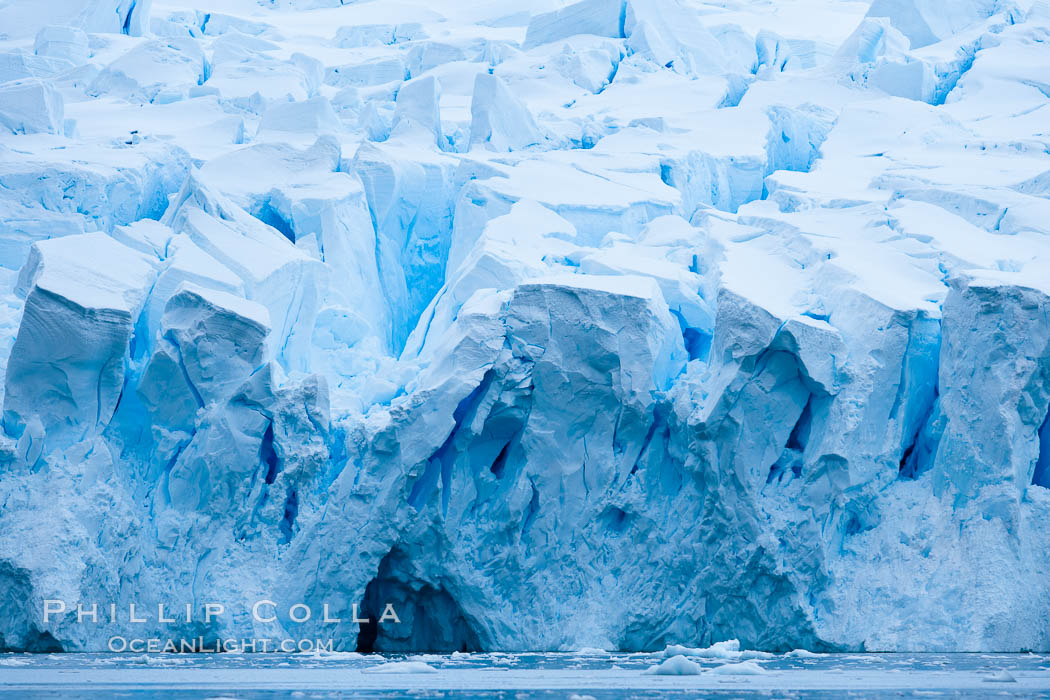 A glacier fractures and cracks, as the leading of a glacier fractures and cracks as it reaches the ocean.  The pieces will float away to become icebergs. Neko Harbor, Antarctic Peninsula, Antarctica, natural history stock photograph, photo id 25655