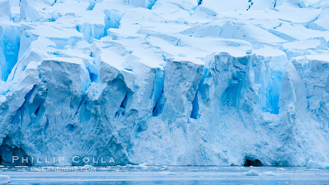 A glacier fractures and cracks, as the leading of a glacier fractures and cracks as it reaches the ocean.  The pieces will float away to become icebergs. Neko Harbor, Antarctic Peninsula, Antarctica, natural history stock photograph, photo id 25741