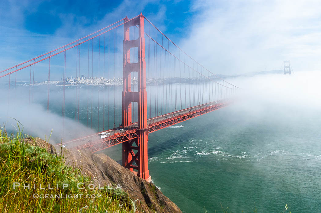 San Franciscos infamous summer fog overtakes the Golden Gate Bridge, viewed from the Marin Headlands with the city of San Francisco visible in the distance. California, USA, natural history stock photograph, photo id 09067