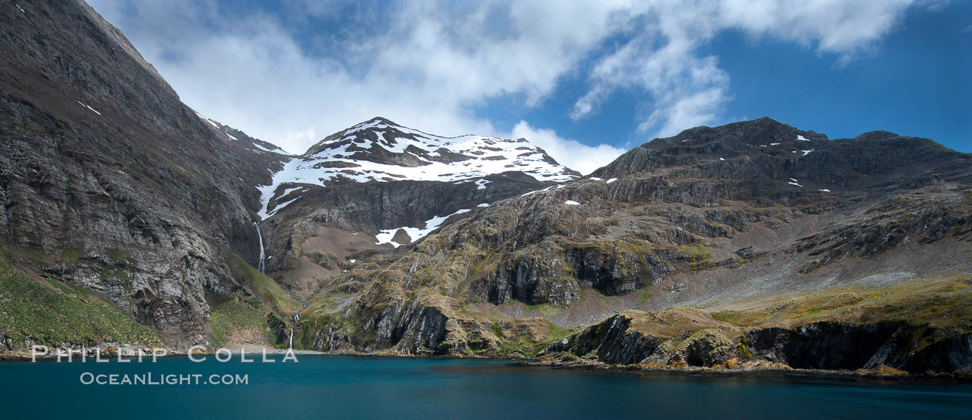 Hercules Bay, with the steep mountains and narrow waterfalls of South Georgia Island rising above., natural history stock photograph, photo id 24417