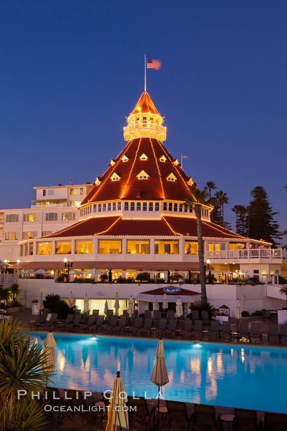 Hotel del Coronado with holiday Christmas night lights, known affectionately as the Hotel Del. It was once the largest hotel in the world, and is one of the few remaining wooden Victorian beach resorts. It sits on the beach on Coronado Island, seen here with downtown San Diego in the distance. It is widely considered to be one of Americas most beautiful and classic hotels. Built in 1888, it was designated a National Historic Landmark in 1977. California, USA, natural history stock photograph, photo id 27396