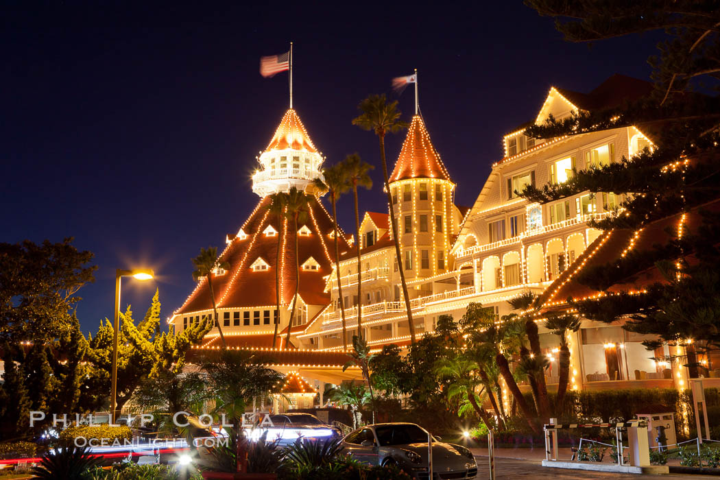 Hotel del Coronado with holiday Christmas night lights, known affectionately as the Hotel Del. It was once the largest hotel in the world, and is one of the few remaining wooden Victorian beach resorts. It sits on the beach on Coronado Island, seen here with downtown San Diego in the distance. It is widely considered to be one of Americas most beautiful and classic hotels. Built in 1888, it was designated a National Historic Landmark in 1977