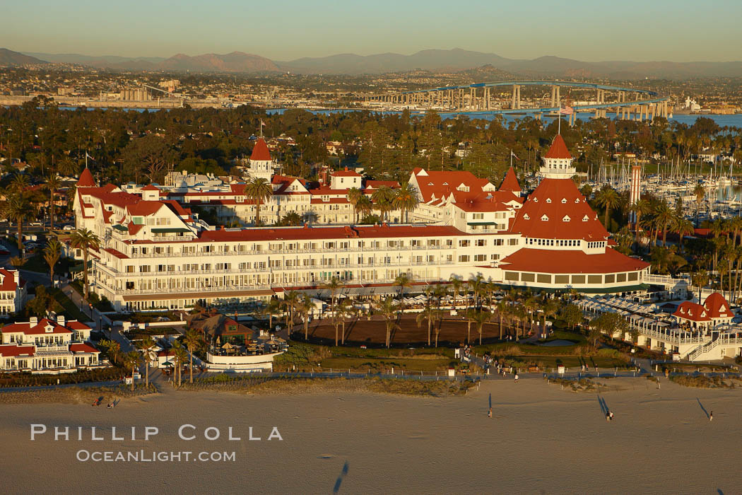 Hotel del Coronado, known affectionately as the Hotel Del.  It was once the largest hotel in the world, and is one of the few remaining wooden Victorian beach resorts.  It sits on the beach on Coronado Island, seen here with downtown San Diego in the distance.  It is widely considered to be one of Americas most beautiful and classic hotels. Built in 1888, it was designated a National Historic Landmark in 1977. California, USA, natural history stock photograph, photo id 22334