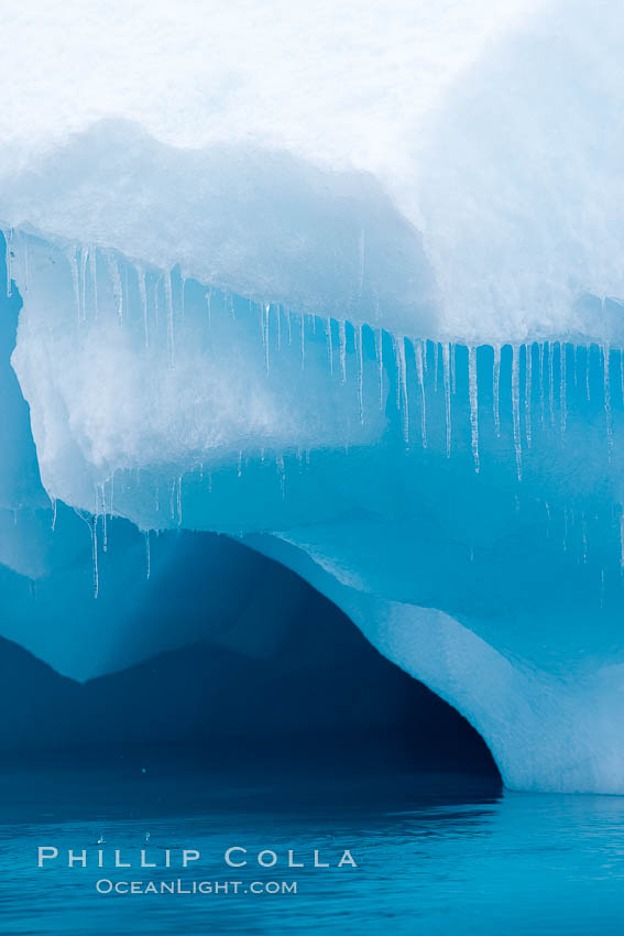 Icicles and melting ice, hanging from the edge of an blue iceberg.  Is this the result of climate change and global warming?. Brown Bluff, Antarctic Peninsula, Antarctica, natural history stock photograph, photo id 24863