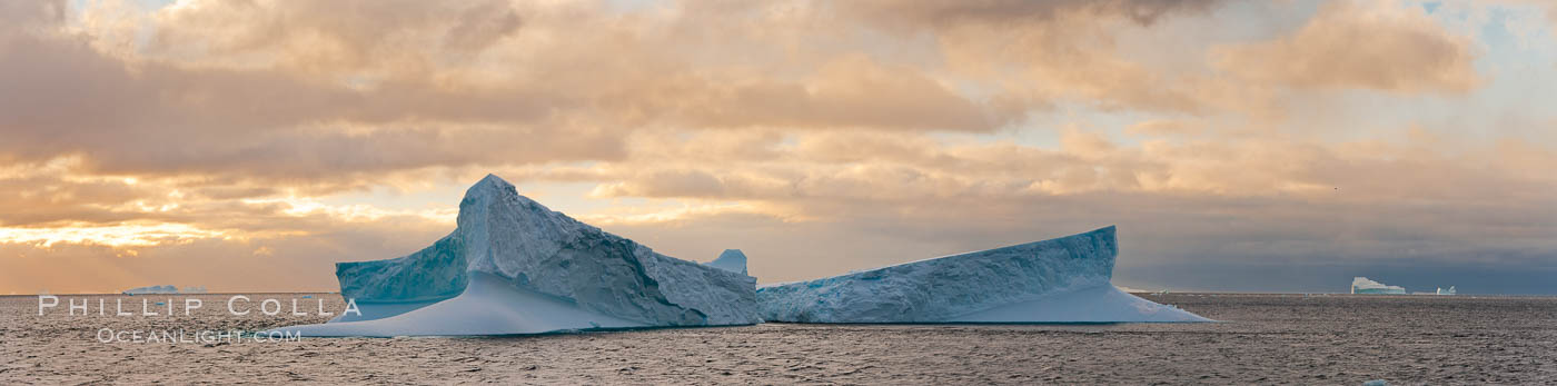 Iceberg panoramic photo.  Iceberg, ocean, light and clouds. Light plays over icebergs and the ocean near Coronation Island. South Orkney Islands, Southern Ocean, natural history stock photograph, photo id 26308
