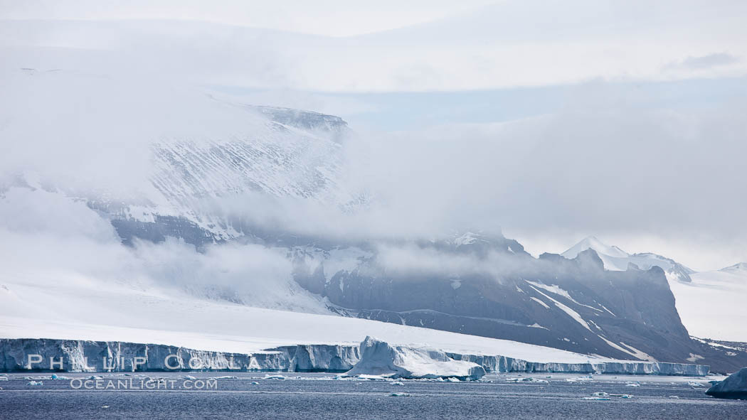 Iceberg and snow-covered coastline, Antarctic Sound. Antarctic Peninsula, Antarctica, natural history stock photograph, photo id 24875
