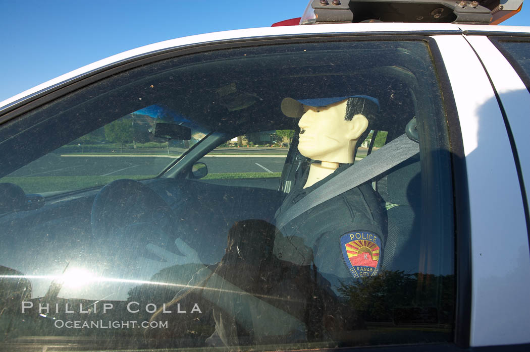 Inflatable cop.  Kanab's Finest, hard at work.  A Kanab police officer actively enforcing the speed limit in the town of Kanab, Utah. USA, natural history stock photograph, photo id 20769