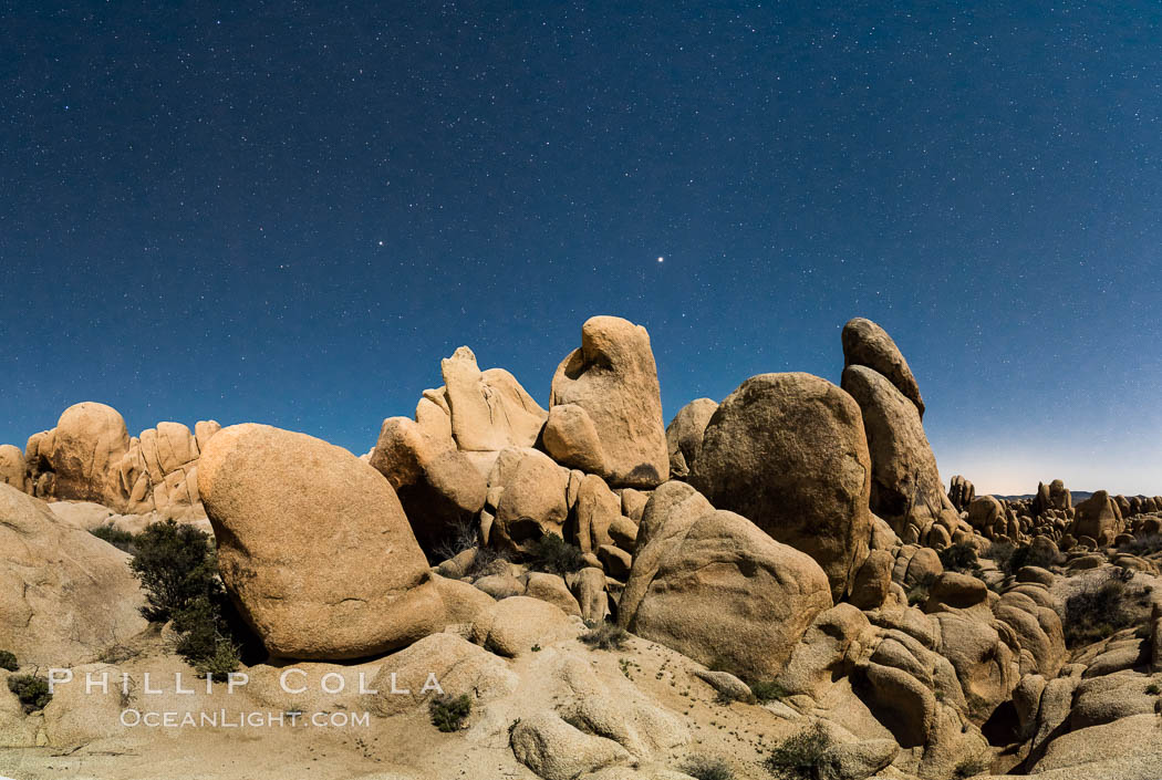 Joshua Tree National Park boulders under a night sky and stars.  Mars is visible in the middle of the image. California, USA, natural history stock photograph, photo id 29194