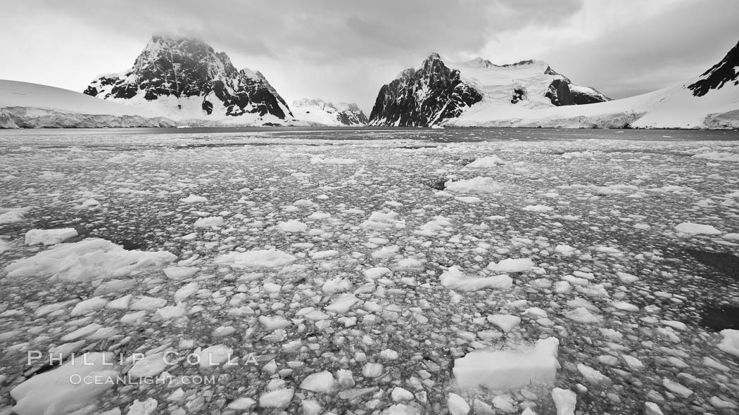 Lemaire Channel: mountains, sea, ice and clouds,Antarctica.  The Lemaire Channel, one of the most scenic places on the Antarctic Peninsula, is a straight 11 km long and only 1.6 km wide at its narrowest point., natural history stock photograph, photo id 25602