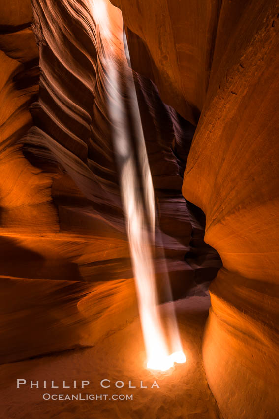 Light Beam in Upper Antelope Slot Canyon.  Thin shafts of light briefly penetrate the convoluted narrows of Upper Antelope Slot Canyon, sending piercing beams through the sandstone maze to the sand floor below. Navajo Tribal Lands, Page, Arizona, USA, natural history stock photograph, photo id 28574