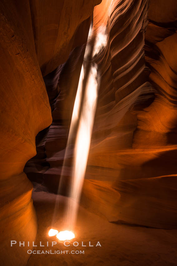 Light Beam in Upper Antelope Slot Canyon.  Thin shafts of light briefly penetrate the convoluted narrows of Upper Antelope Slot Canyon, sending piercing beams through the sandstone maze to the sand floor below. Navajo Tribal Lands, Page, Arizona, USA, natural history stock photograph, photo id 28573