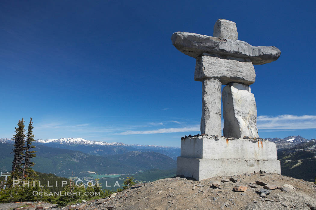 Ilanaaq, the logo of the 2010 Winter Olympics in Vancouver, is formed of stone in the Inukshuk-style of traditional Inuit sculpture.  Located near the Whistler mountain gondola station, overlooking Whistler Village and Green Lake in the distance. British Columbia, Canada, natural history stock photograph, photo id 21008
