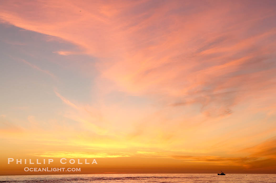 A lone lobster boat works its traps at sunset off the coast of Carlsbad., natural history stock photograph, photo id 14650
