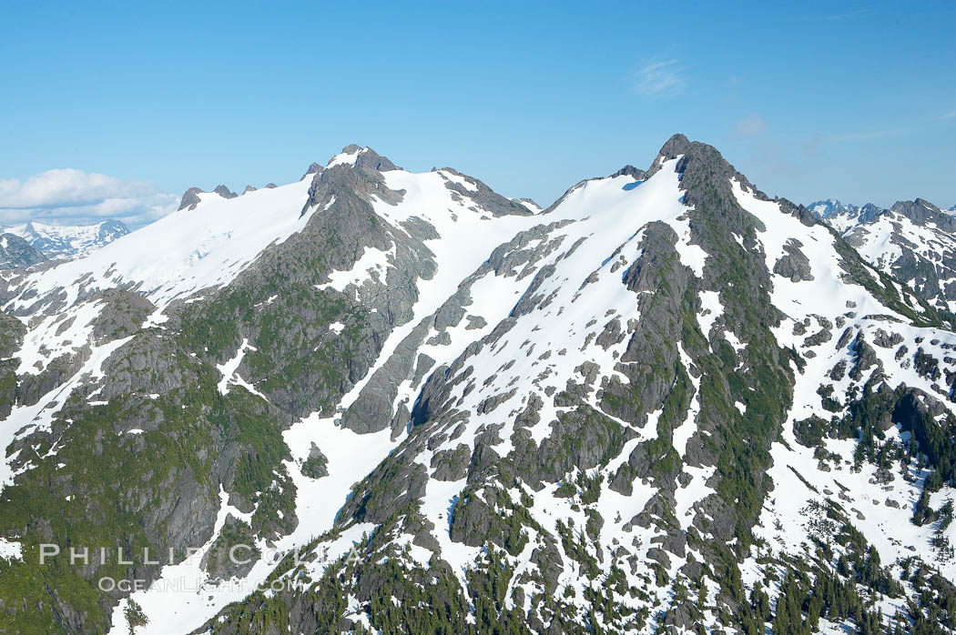 Mariner Mountain, viewed from the northwest, on the west coast of Vancouver Island, British Columbia, Canada, part of Strathcona Provincial Park, located 36 km (22 mi) north of Tofino.  It is 1,771 m (5,810 ft) high, snow covered year-round and home to several glaciers., natural history stock photograph, photo id 21103