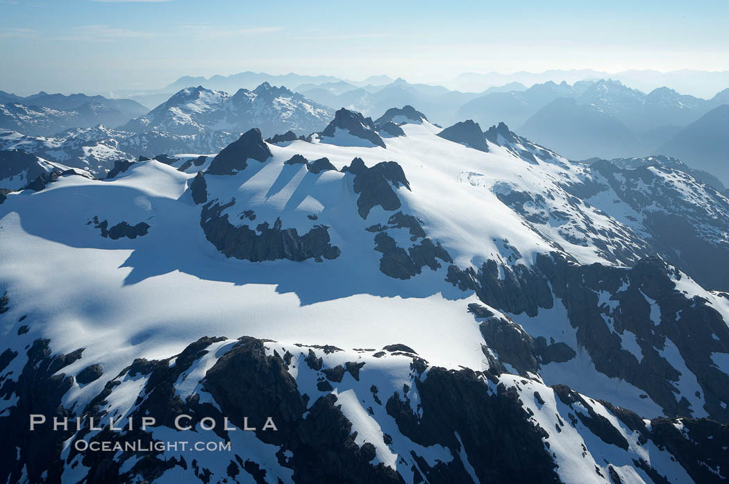 Mariner Mountain, on the west coast of Vancouver Island, British Columbia, Canada, part of Strathcona Provincial Park, located 36 km (22 mi) north of Tofino.  It is 1,771 m (5,810 ft) high, snow covered year-round and home to several glaciers., natural history stock photograph, photo id 21107