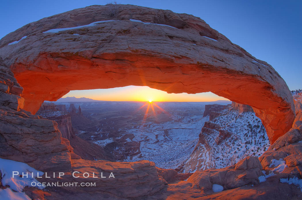Mesa Arch spans 90 feet and stands at the edge of a mesa precipice thousands of feet above the Colorado River gorge. For a few moments at sunrise the underside of the arch glows dramatically red and orange. Island in the Sky, Canyonlands National Park, Utah, USA, natural history stock photograph, photo id 18042