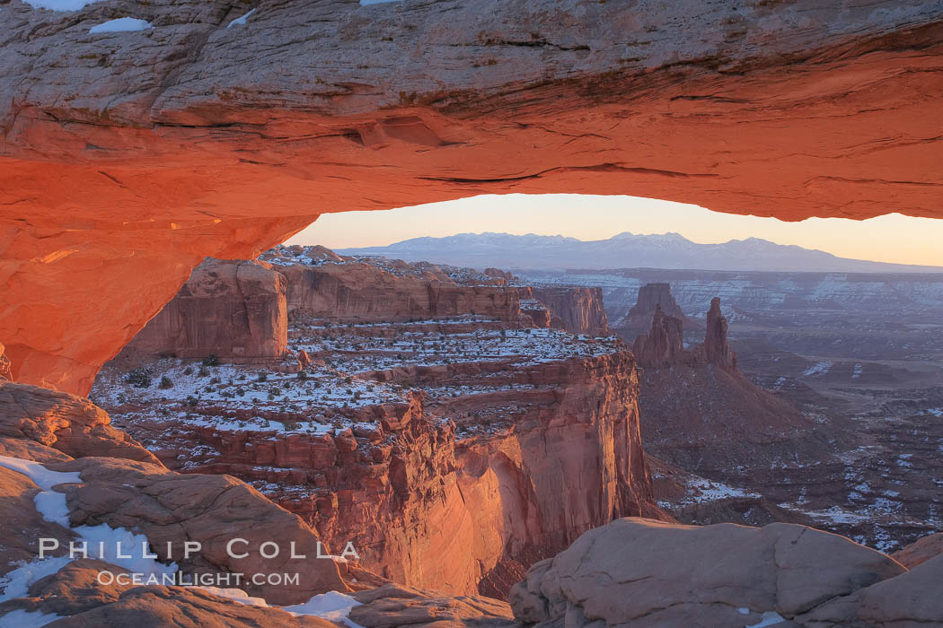 Mesa Arch spans 90 feet and stands at the edge of a mesa precipice thousands of feet above the Colorado River gorge. For a few moments at sunrise the underside of the arch glows dramatically red and orange. Island in the Sky, Canyonlands National Park, Utah, USA, natural history stock photograph, photo id 18082