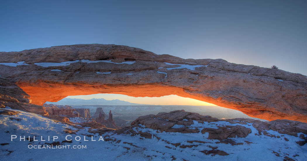Mesa Arch spans 90 feet and stands at the edge of a mesa precipice thousands of feet above the Colorado River gorge. For a few moments at sunrise the underside of the arch glows dramatically red and orange. Island in the Sky, Canyonlands National Park, Utah, USA, natural history stock photograph, photo id 18076