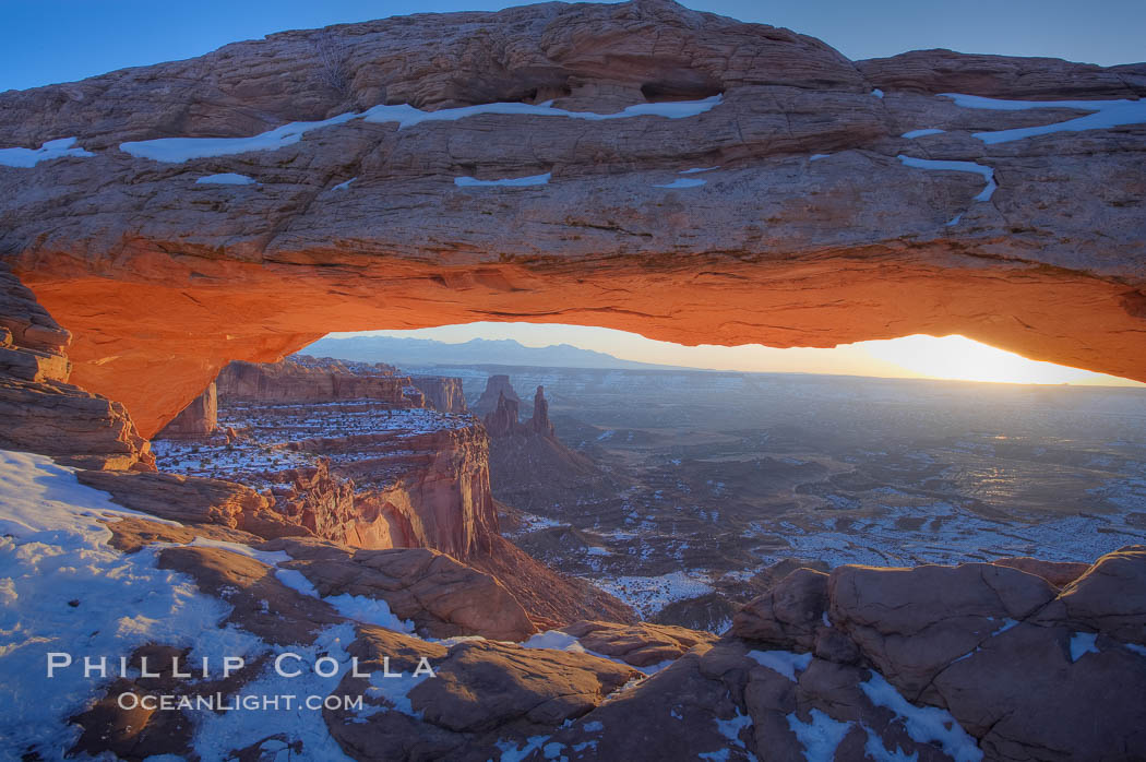 Mesa Arch spans 90 feet and stands at the edge of a mesa precipice thousands of feet above the Colorado River gorge. For a few moments at sunrise the underside of the arch glows dramatically red and orange. Island in the Sky, Canyonlands National Park, Utah, USA, natural history stock photograph, photo id 18039