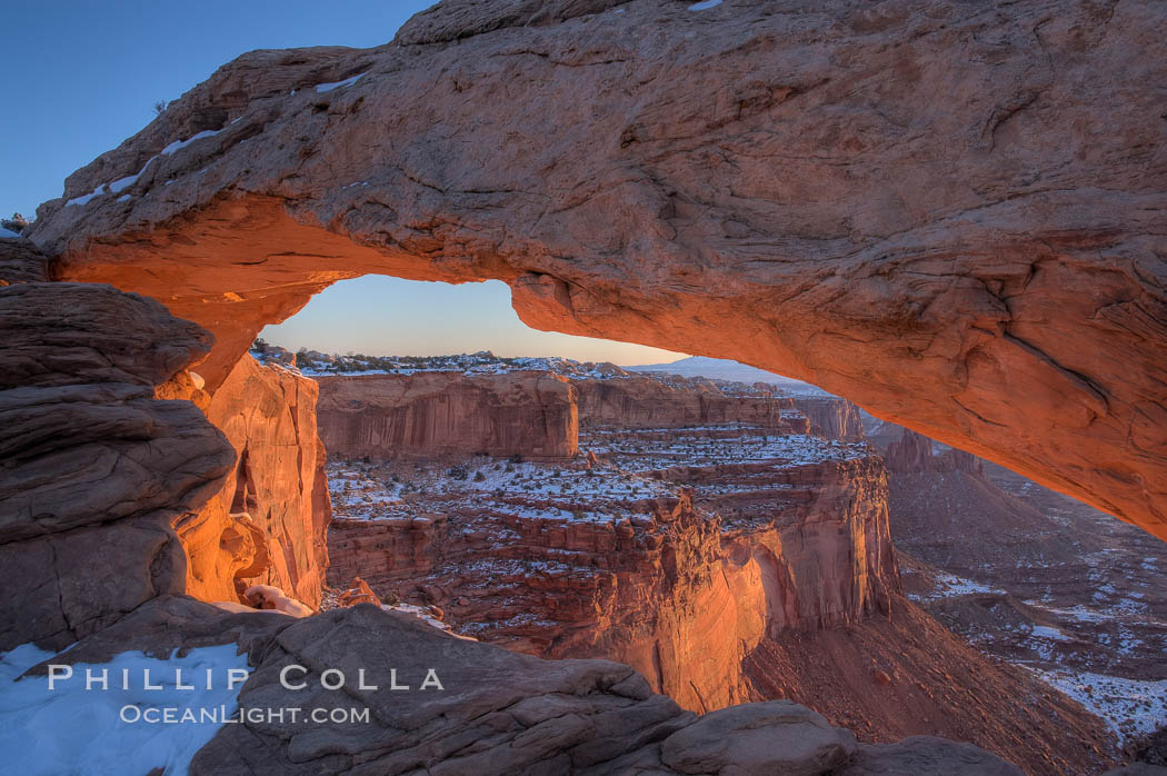 Mesa Arch spans 90 feet and stands at the edge of a mesa precipice thousands of feet above the Colorado River gorge. For a few moments at sunrise the underside of the arch glows dramatically red and orange. Island in the Sky, Canyonlands National Park, Utah, USA, natural history stock photograph, photo id 18081