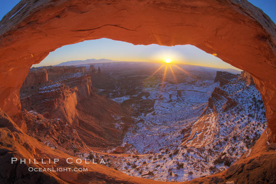 Mesa Arch spans 90 feet and stands at the edge of a mesa precipice thousands of feet above the Colorado River gorge. For a few moments at sunrise the underside of the arch glows dramatically red and orange. Island in the Sky, Canyonlands National Park, Utah, USA, natural history stock photograph, photo id 18085